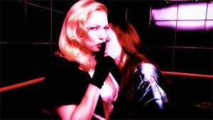 Traci Lords in bathroom with girl resting on her shoulder