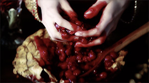 hands digging in cranberry pie