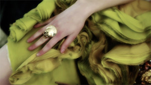 fashion models hand on yellow dress with skull ring