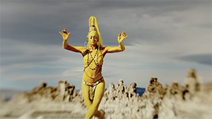 Oxum amy secada in yellow paint dancing in desert