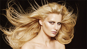 Fashion model in studio with hair blowing in wind