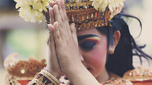 Balinese girl with traditional costume praying